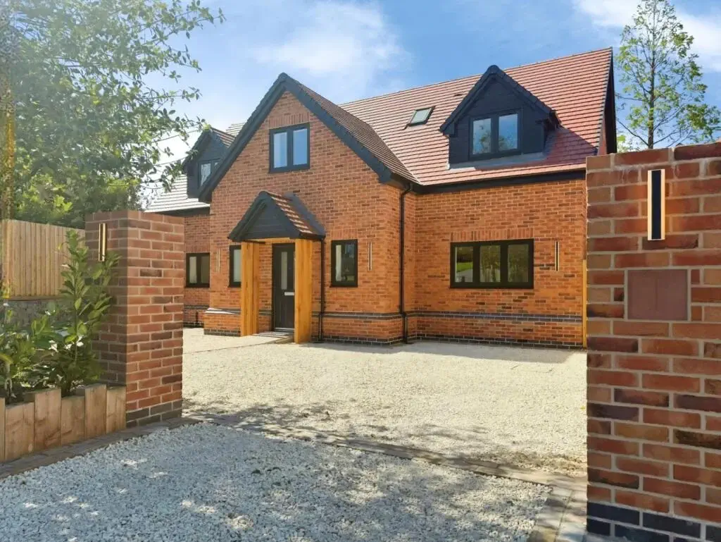 Detached brick new-build home forming part of a residential development in Cheshire