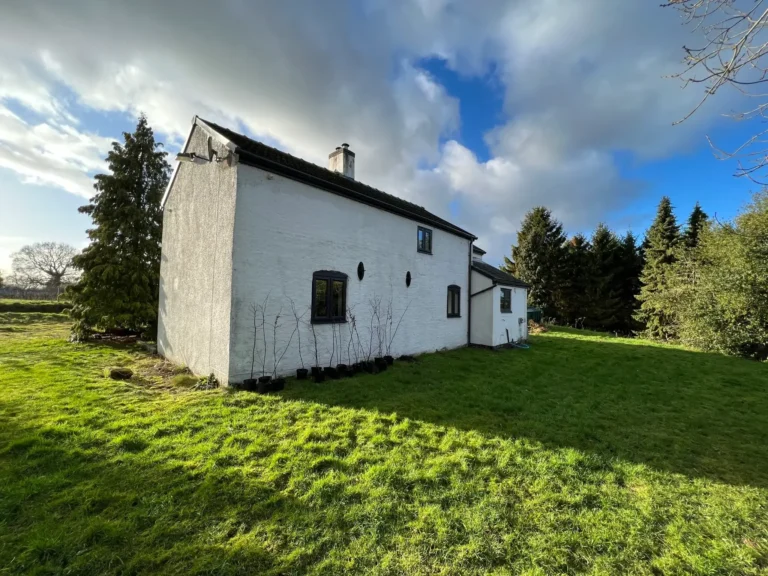Existing side elevation and garden at The Sheiling before rural redevelopment in Doddington
